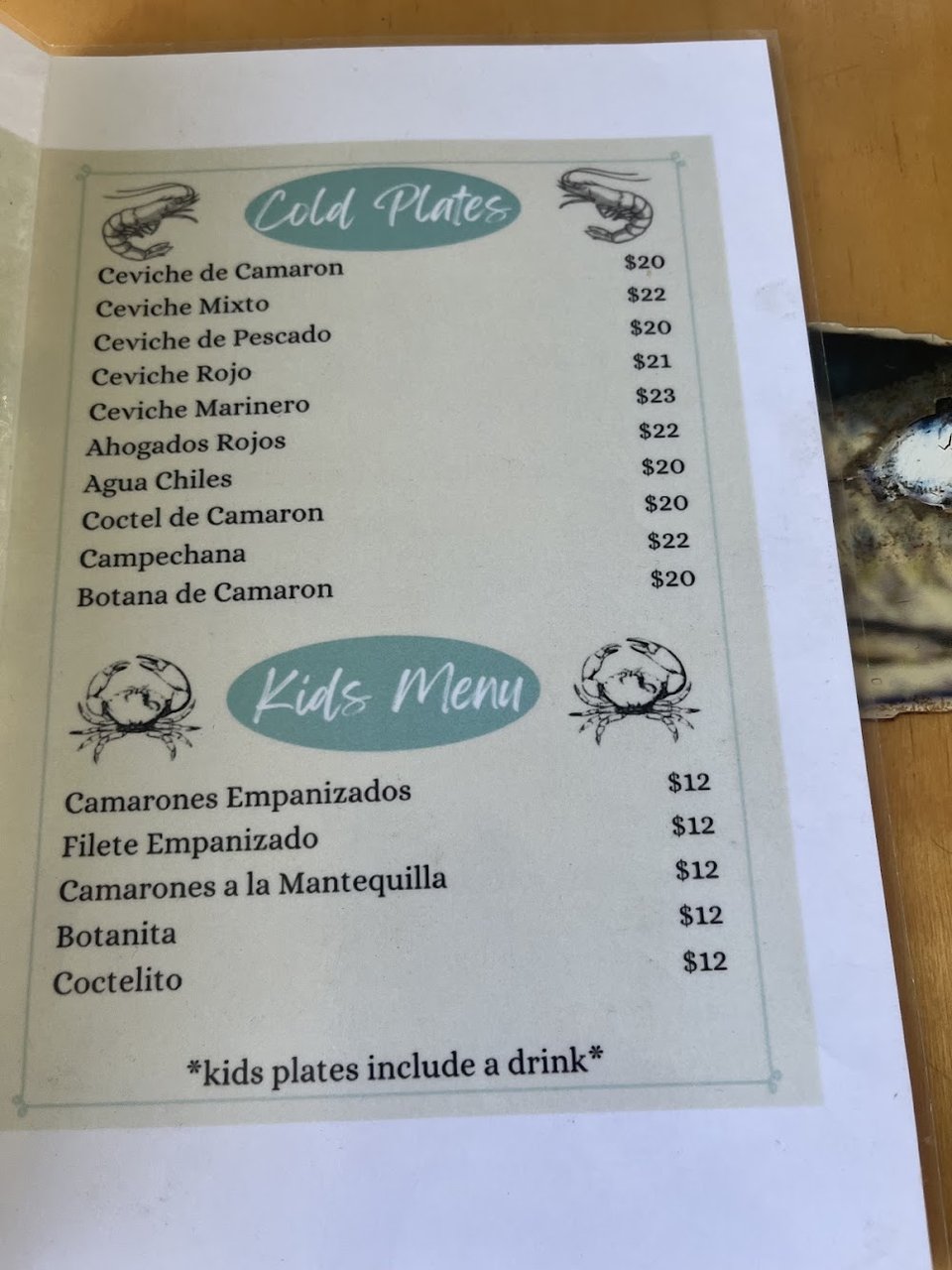 Printed menu with cocktails and small plates.